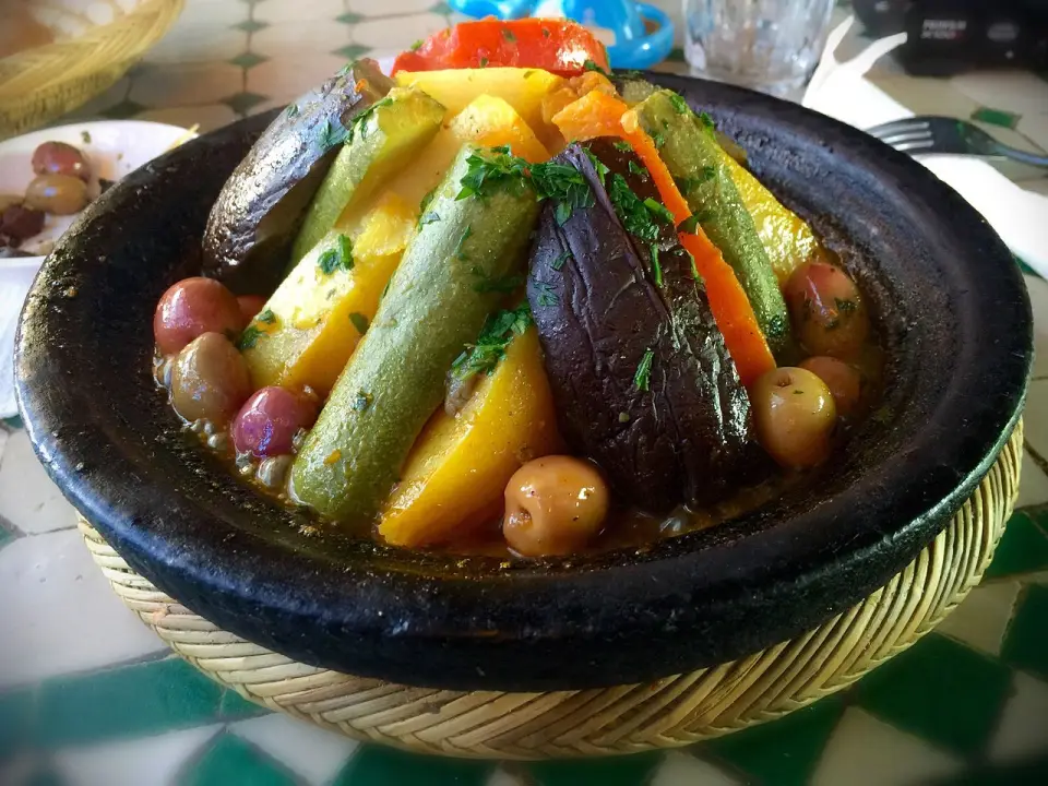 A vegetable tagine with eggplant, carrot, zucchini and potatoes arranged in a cone